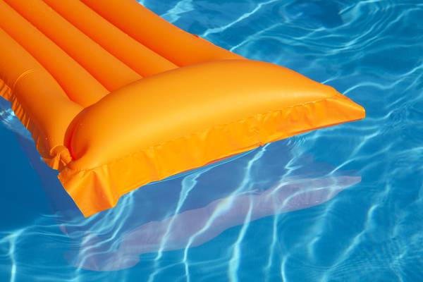 Woman found asleep on inflatable mattress floating in pool accused of burglary